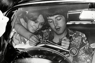 Paul McCartney at the wheel of his DB6 with a fan