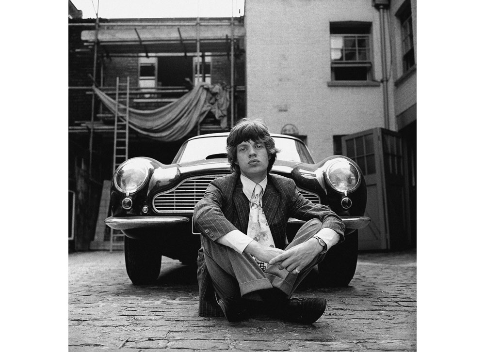 With that now famous pout already perfected, a youthful Mick Jagger poses for Gered Mankowitz with the DB6 in the summer of 1966